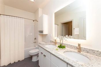 A bathroom with a toilet, sink, and shower